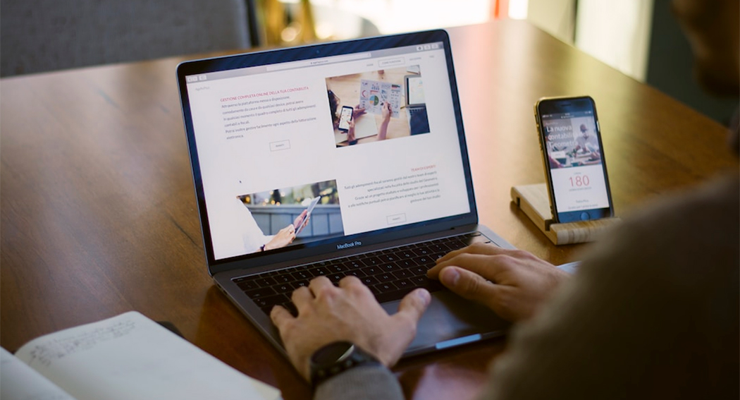 A man goes over a document on his laptop